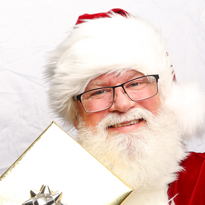 Santa David, retired social worker and military veteran, sharing Christmas magic with children and families